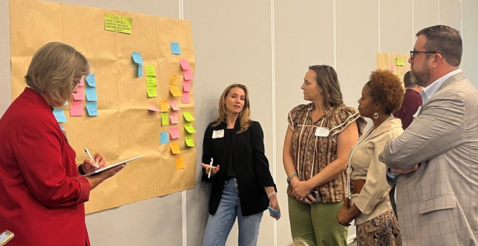 Cathy-pic-Dr-j-taking-notes-with-group